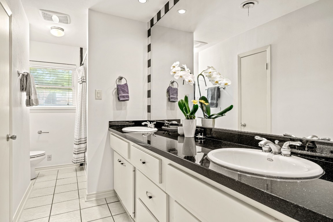 5827 Rutherglenn Drive Houston, TX 77096 - Photo 17 of 30 a bathroom with a sink and a mirror