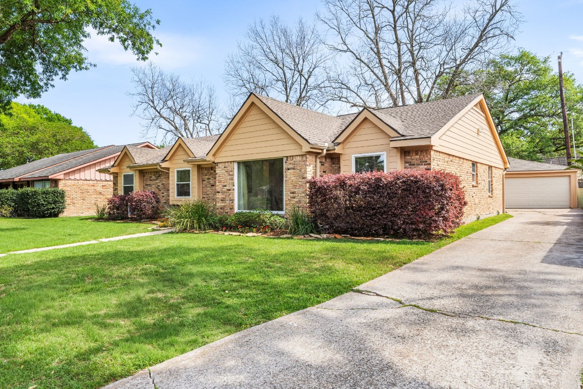 5827 Rutherglenn Drive Houston, TX 77096 - Photo 2 of 30 a front view of a house with garden
