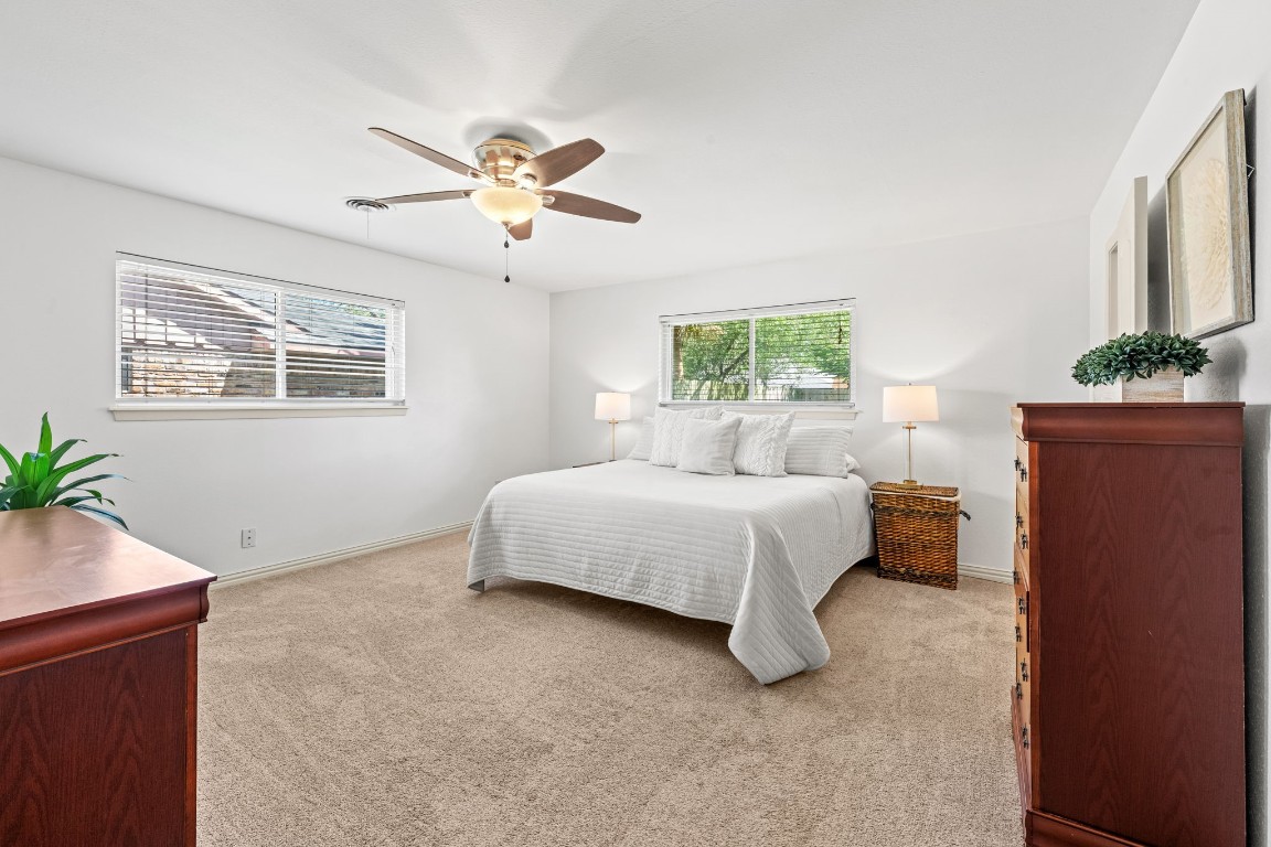 5827 Rutherglenn Drive Houston, TX 77096 - Photo 19 of 30 a spacious bedroom with a bed and a window