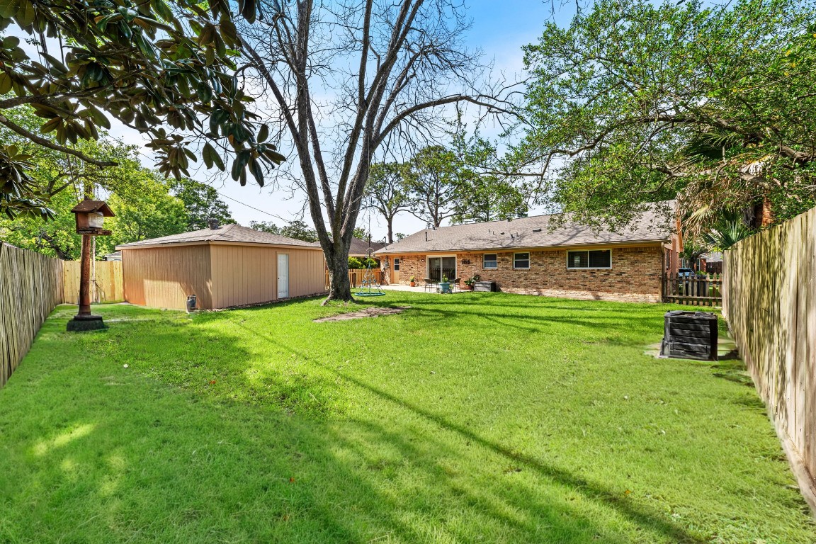 5827 Rutherglenn Drive Houston, TX 77096 - Photo 26 of 30 front view of a house with a yard
