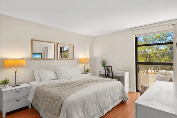 a bedroom with a large bed and a lamp on table
