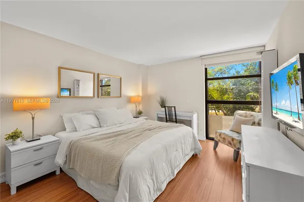 a bedroom with a large bed and a large window