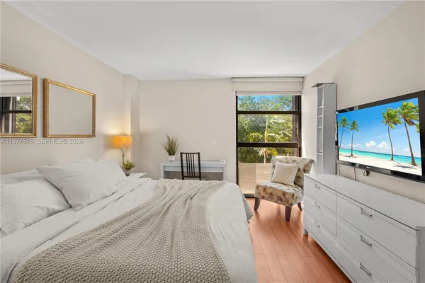 a bedroom with a large bed and a large window