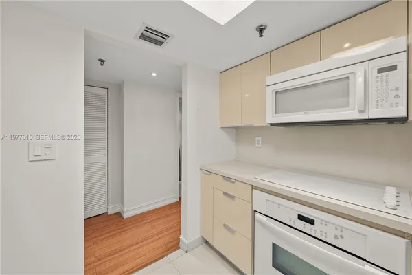 a kitchen with stainless steel appliances cabinets and a potted plant