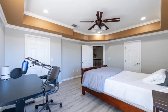 a bedroom with a bed a desk and chair