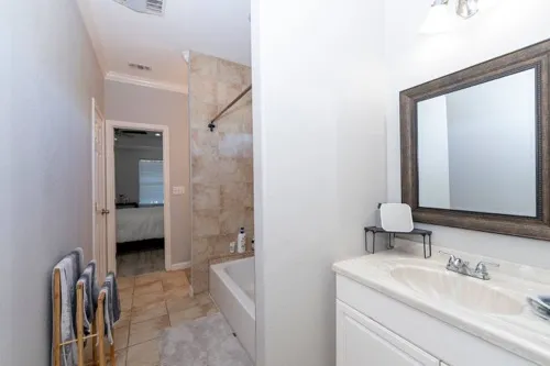 a en suite bathroom with a sink a mirror and a shower