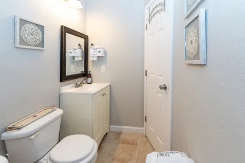 a white toilet sitting next to a bathroom sink