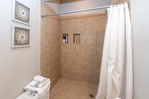 a bathroom with a shower and a sink