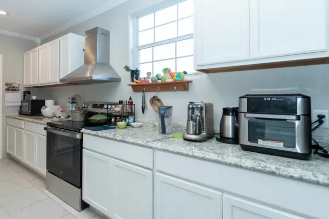 a kitchen with granite countertop a sink stainless steel appliances and cabinets