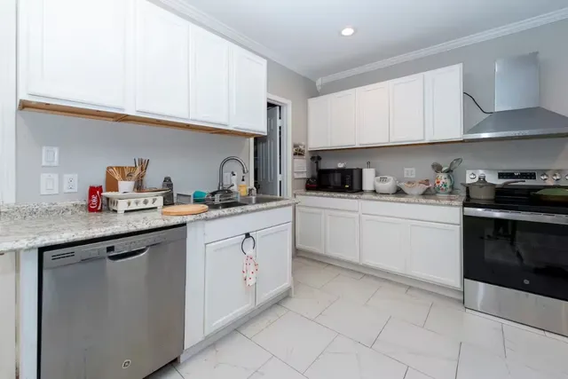 a kitchen with granite countertop a sink and cabinets