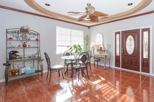 a dining room with furniture a rug and a chandelier