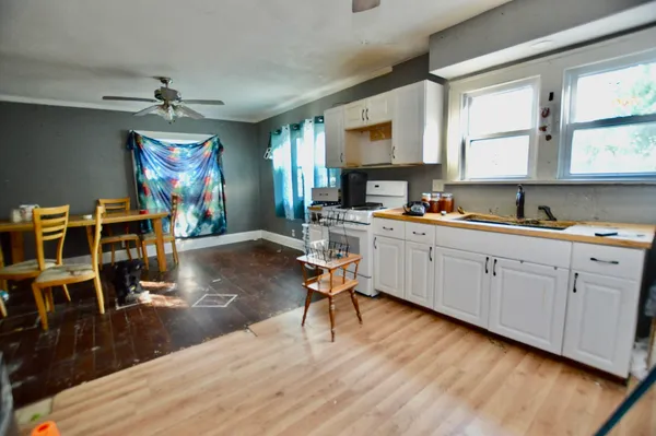 a view of a kitchen with workspace and wooden floor
