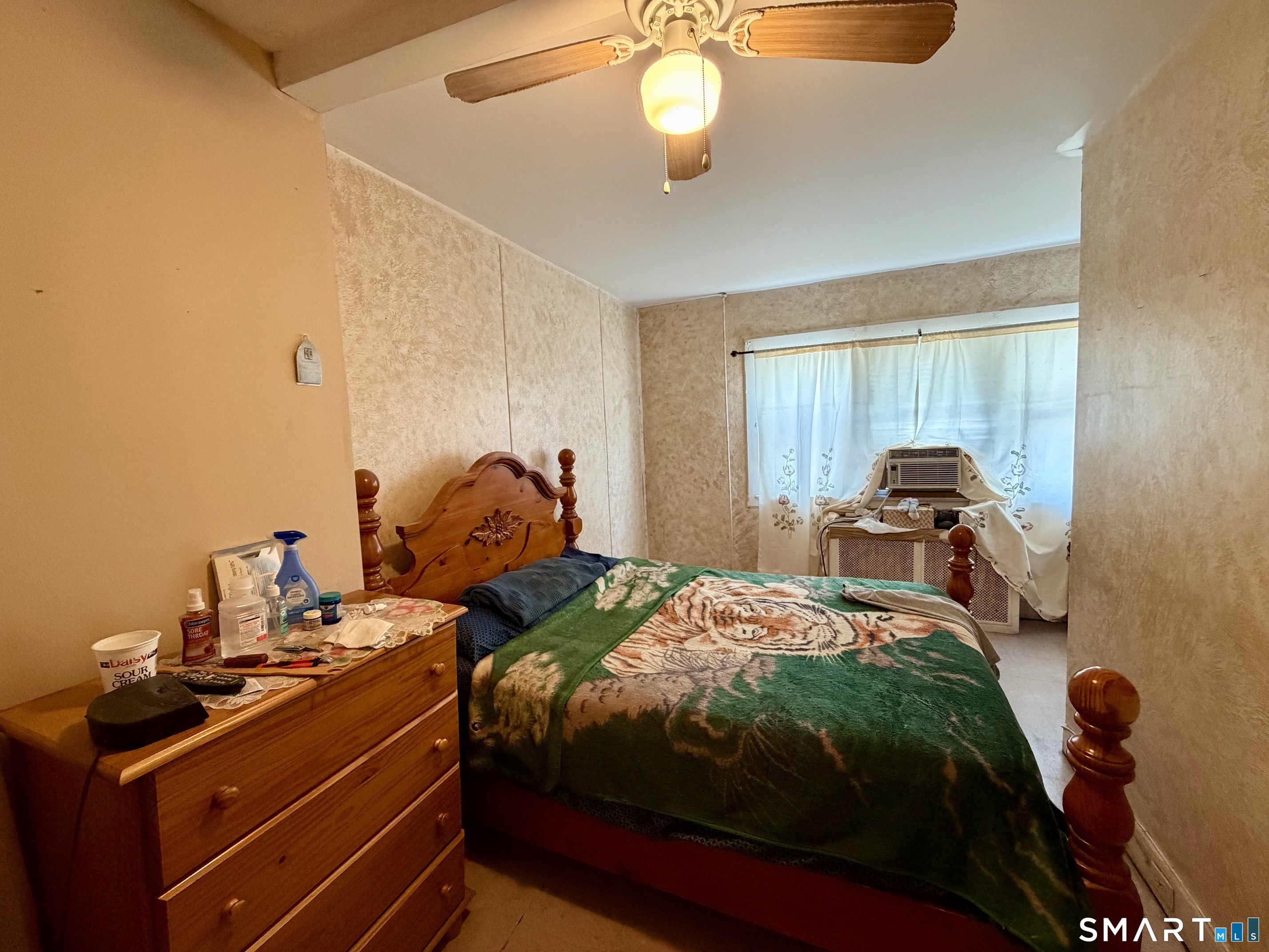 111 Waterman Street Bridgeport, CT 06607 - Photo 12 of 14 a bedroom with a bed and a chandelier