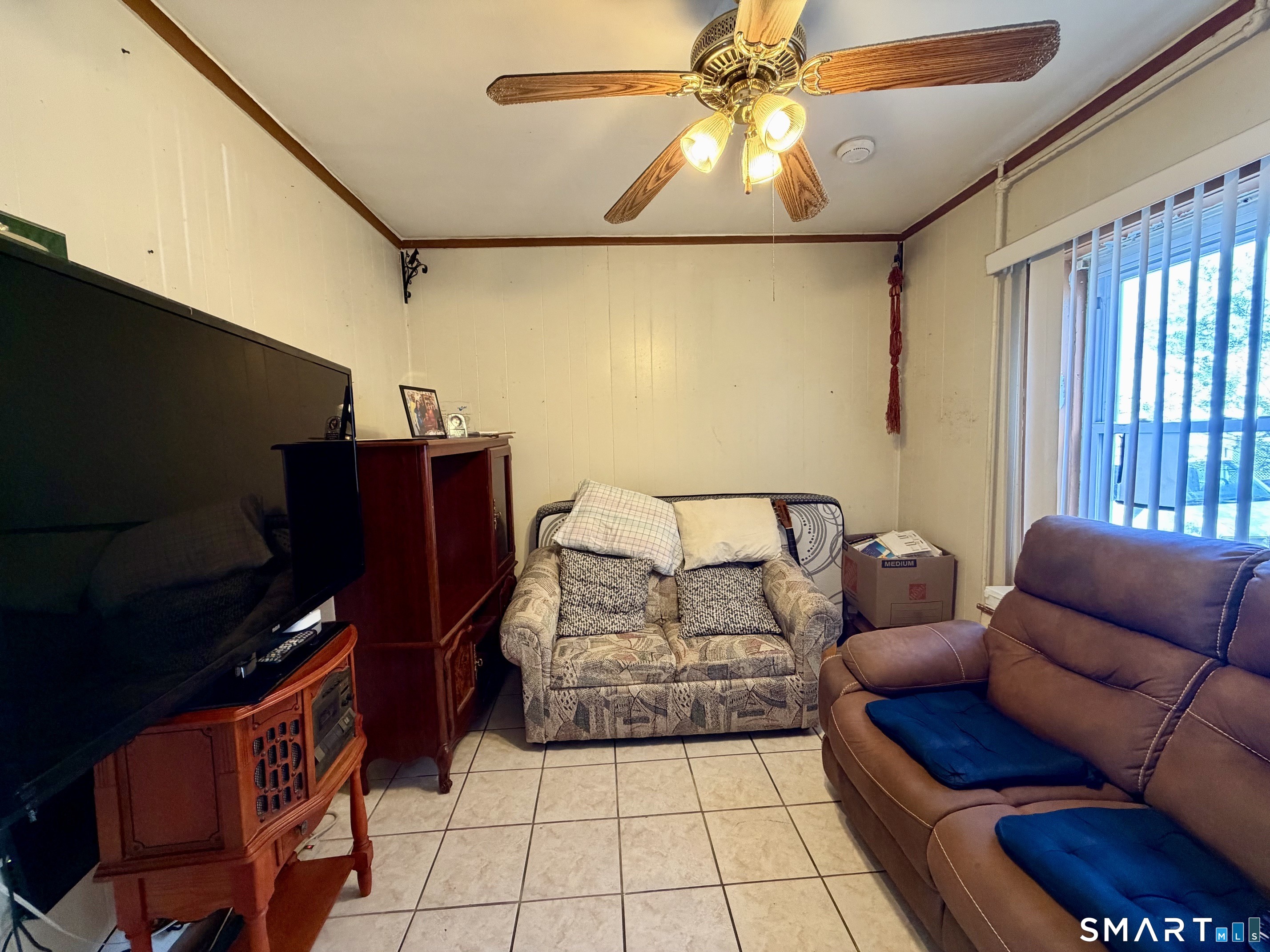 111 Waterman Street Bridgeport, CT 06607 - Photo 2 of 14 a living room with furniture and a flat screen tv