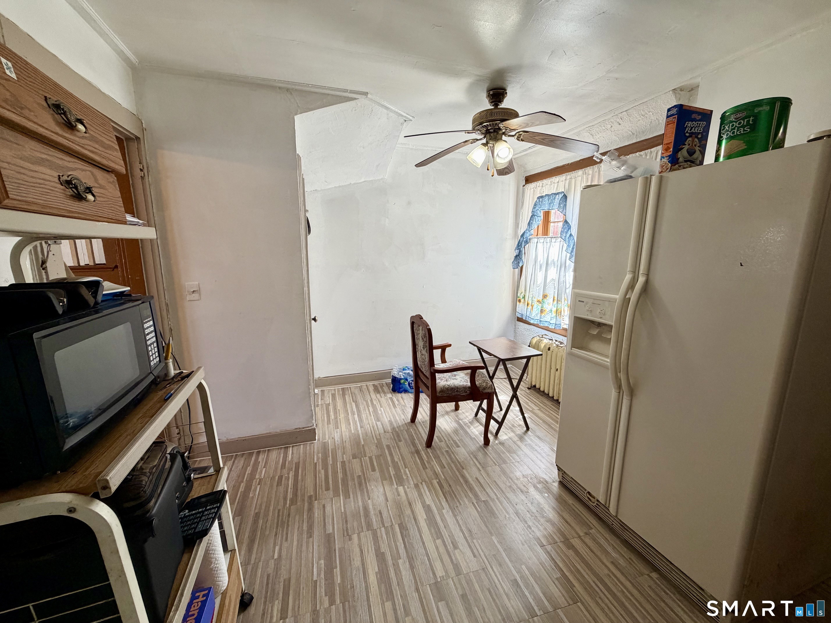 111 Waterman Street Bridgeport, CT 06607 - Photo 7 of 14 a view of a room with furniture and wooden floor