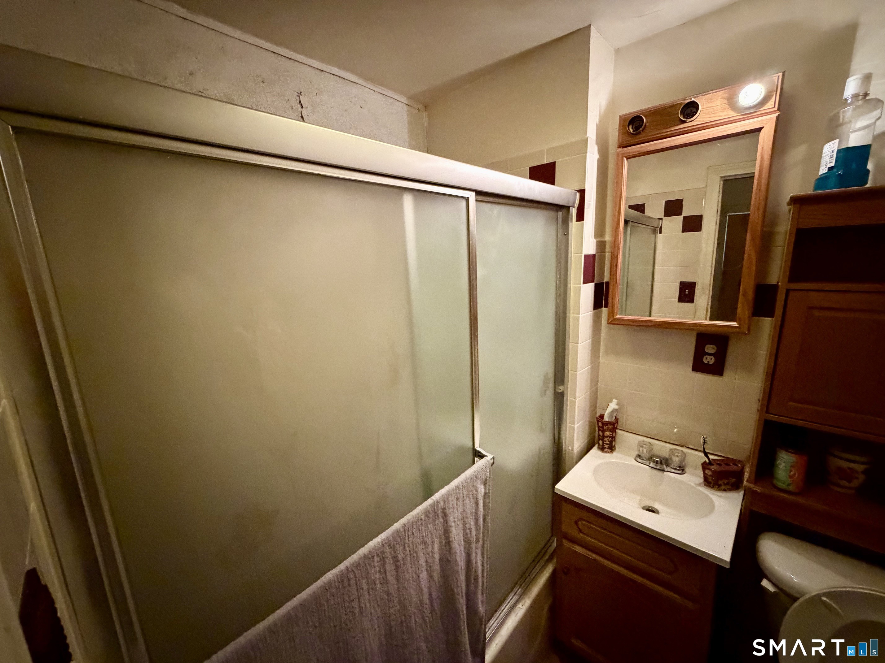 111 Waterman Street Bridgeport, CT 06607 - Photo 10 of 14 a bathroom with a sink and mirror
