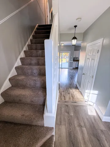a view of entryway and hall with wooden floor