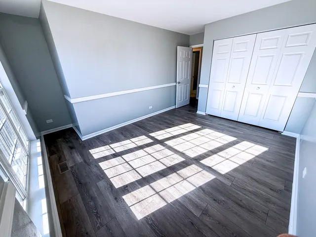 a view of an empty room and wooden floor