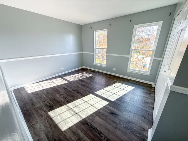 a view of wooden floor and windows in a room