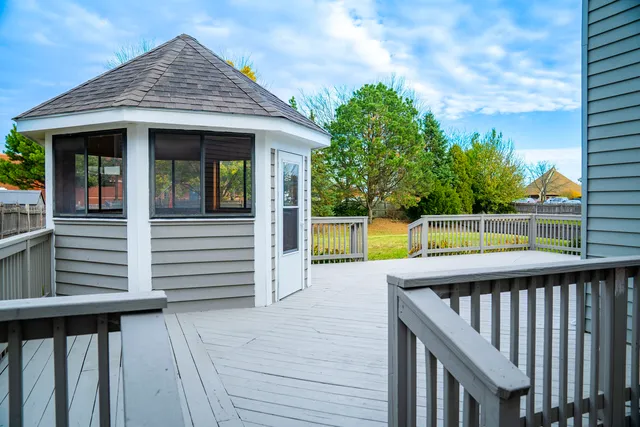 a view of a house with backyard and deck