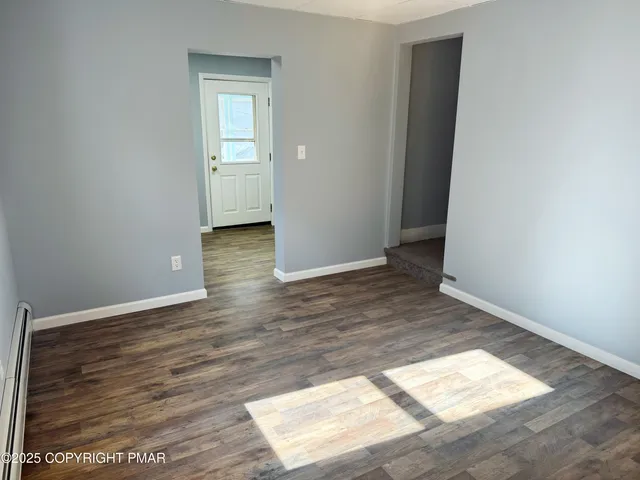an empty room with wooden floor and closet