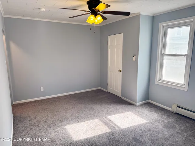 a view of an empty room with a window