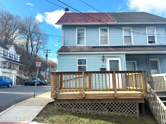 a view of a house with a wooden deck