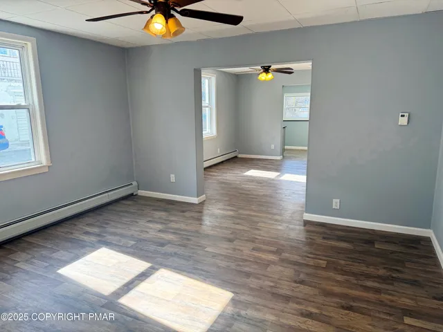 wooden floor in an empty room with a window