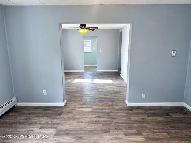 a view of a livingroom with wooden floor
