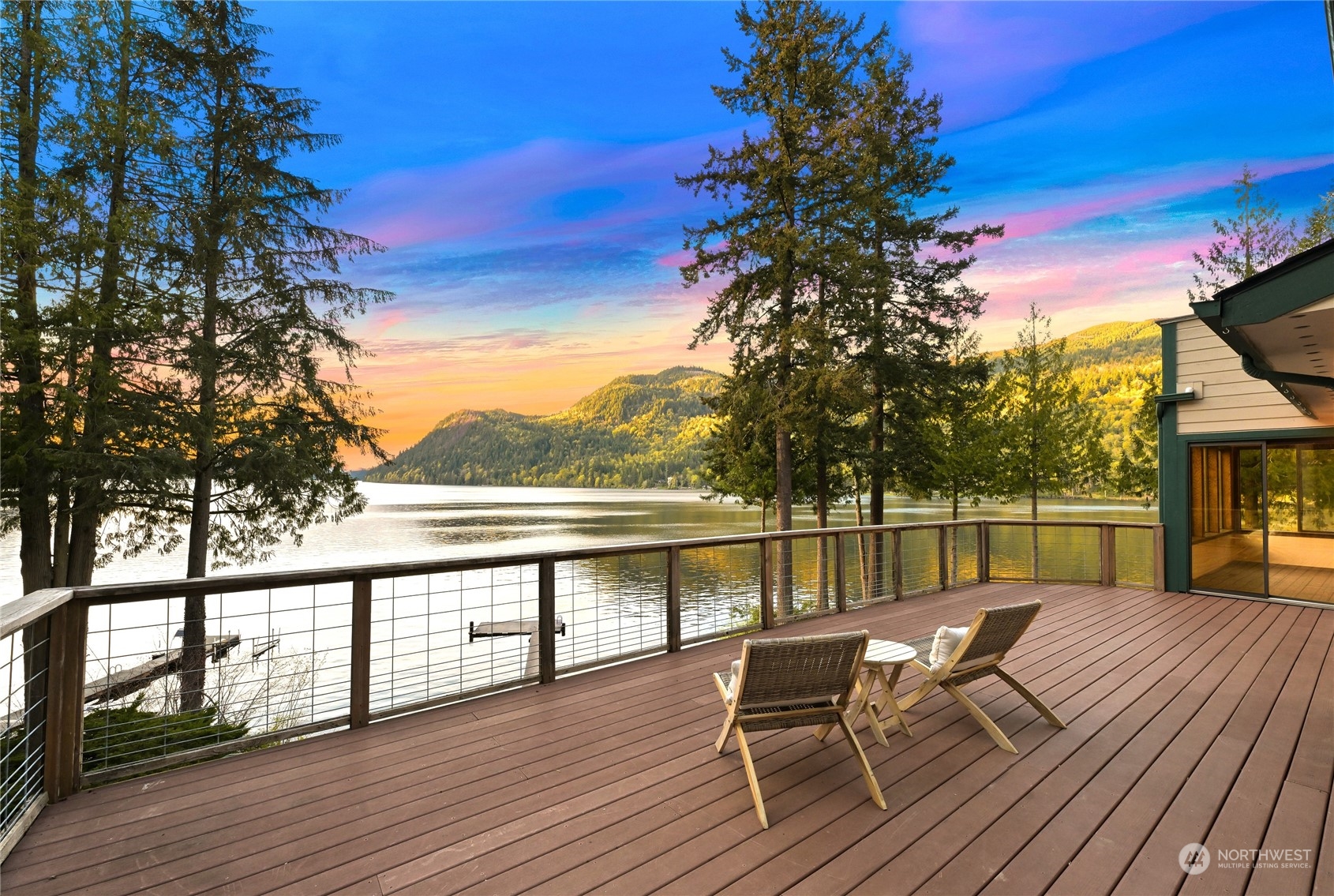 a view of a lake from deck with patio