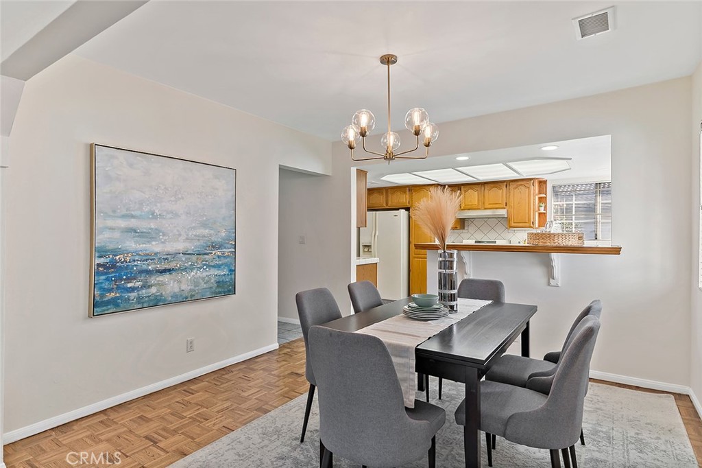 12216 Old River School Road Downey, CA 90242 - Photo 11 of 36 a view of a dining room with furniture wooden floor and chandelier