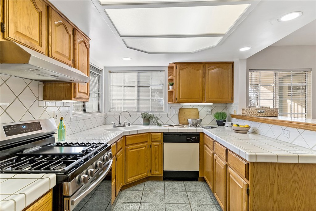 12216 Old River School Road Downey, CA 90242 - Photo 13 of 36 a kitchen that has a sink and a stove in it