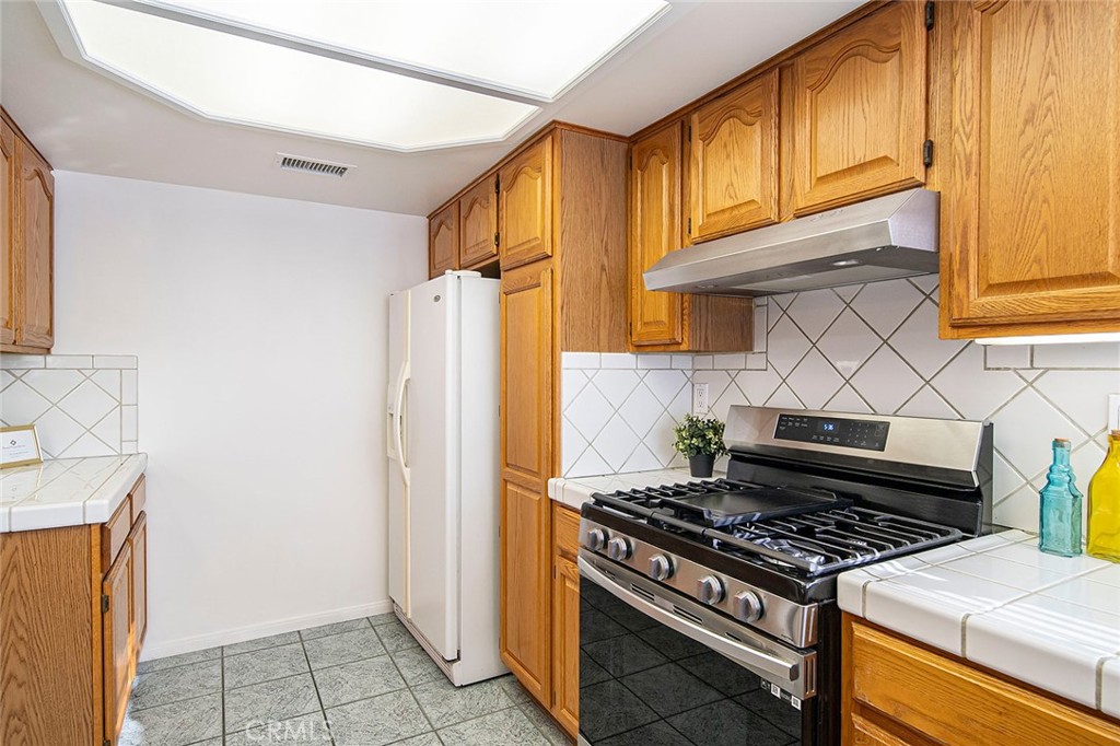 12216 Old River School Road Downey, CA 90242 - Photo 14 of 36 a kitchen with a stove and a refrigerator
