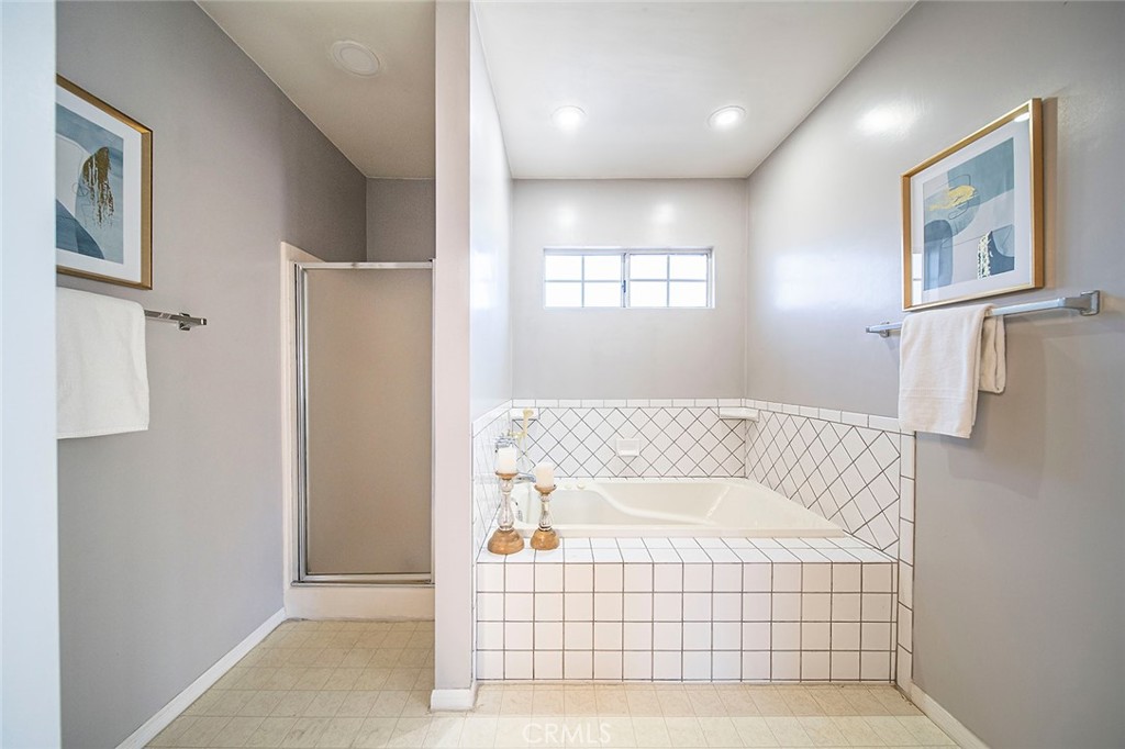 12216 Old River School Road Downey, CA 90242 - Photo 24 of 36 a bathroom with a bathtub and window