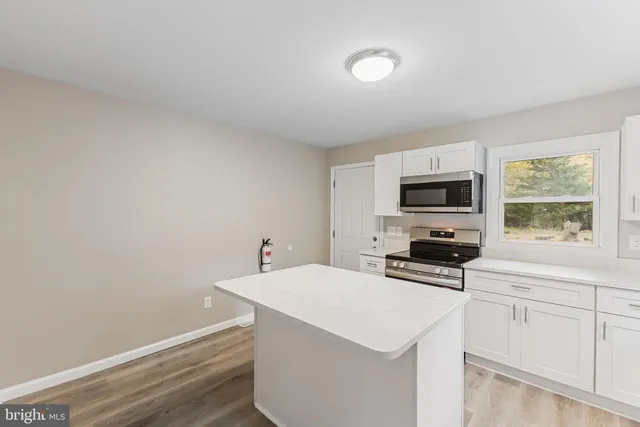 a kitchen with a sink a stove and cabinets