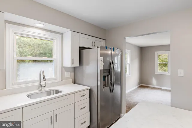 a kitchen with a sink appliances and cabinets