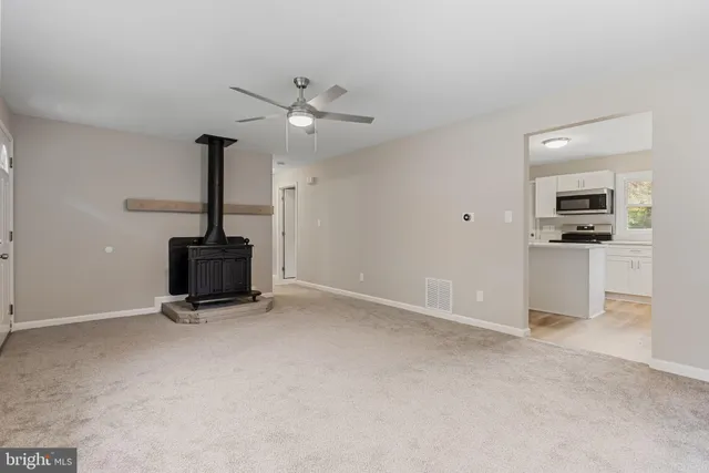 a view of an empty room with a fireplace