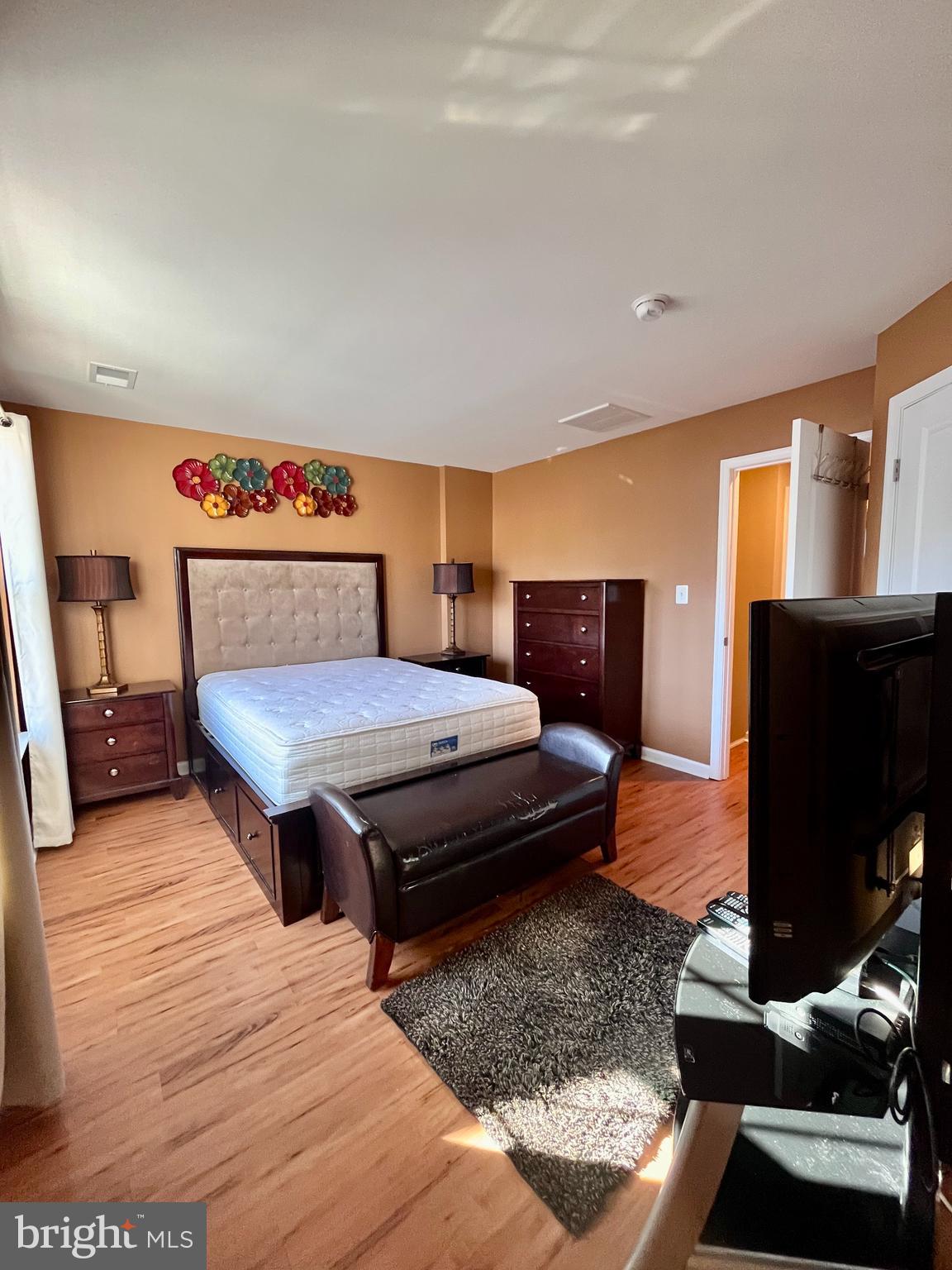 312 Spring Park Lane, Unit 59 Fredericksburg, VA 22405 - Photo 16 of 20 a bedroom with a bed and flat screen tv