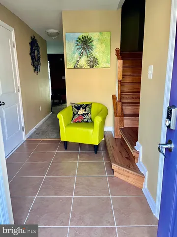 a living room with a rug and a painting on the wall