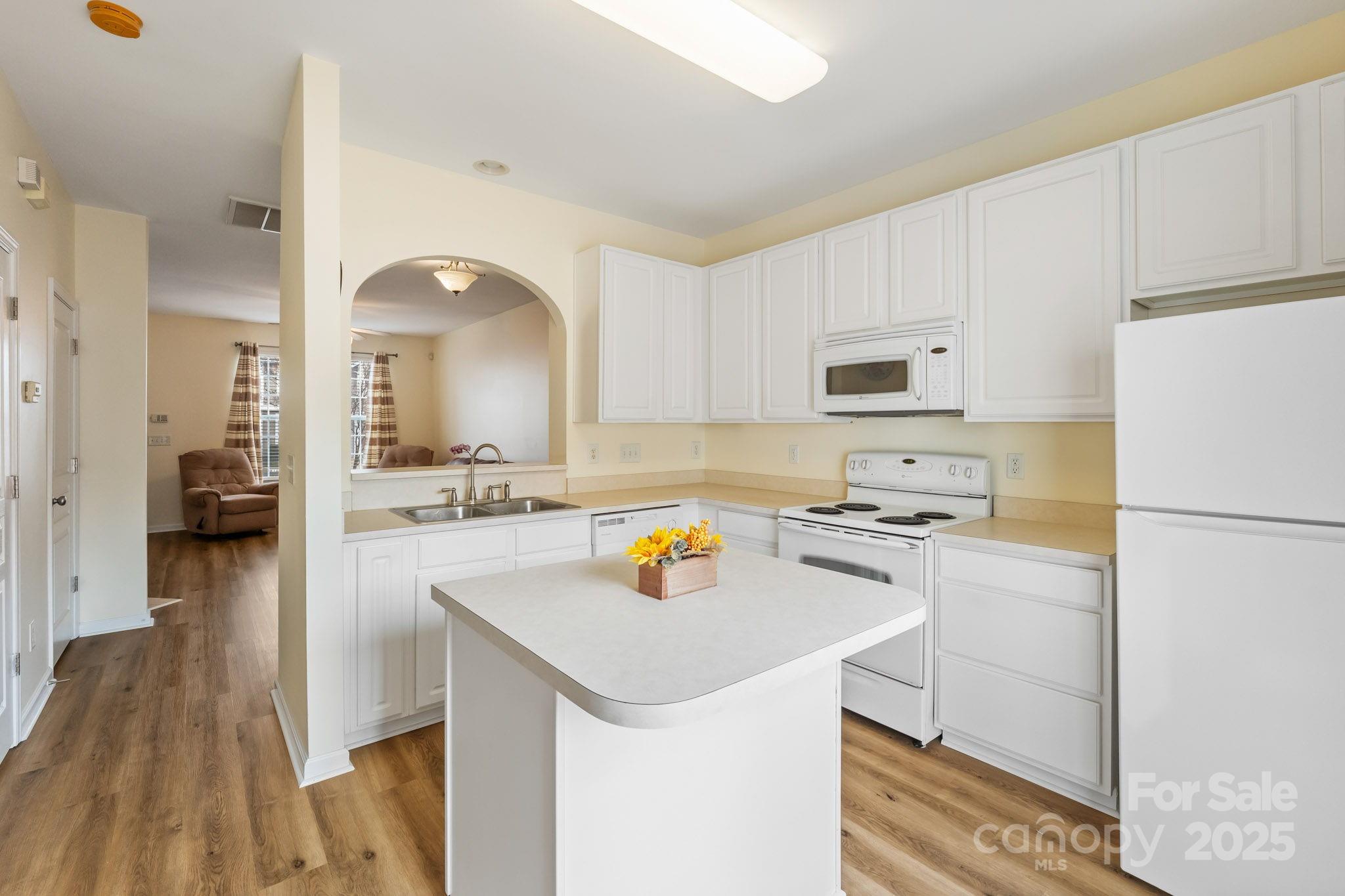 811 Gentlewinds Court Fort Mill, SC 29708 - Photo 12 of 25 a kitchen with a refrigerator a stove a sink dishwasher and a stove with wooden floor