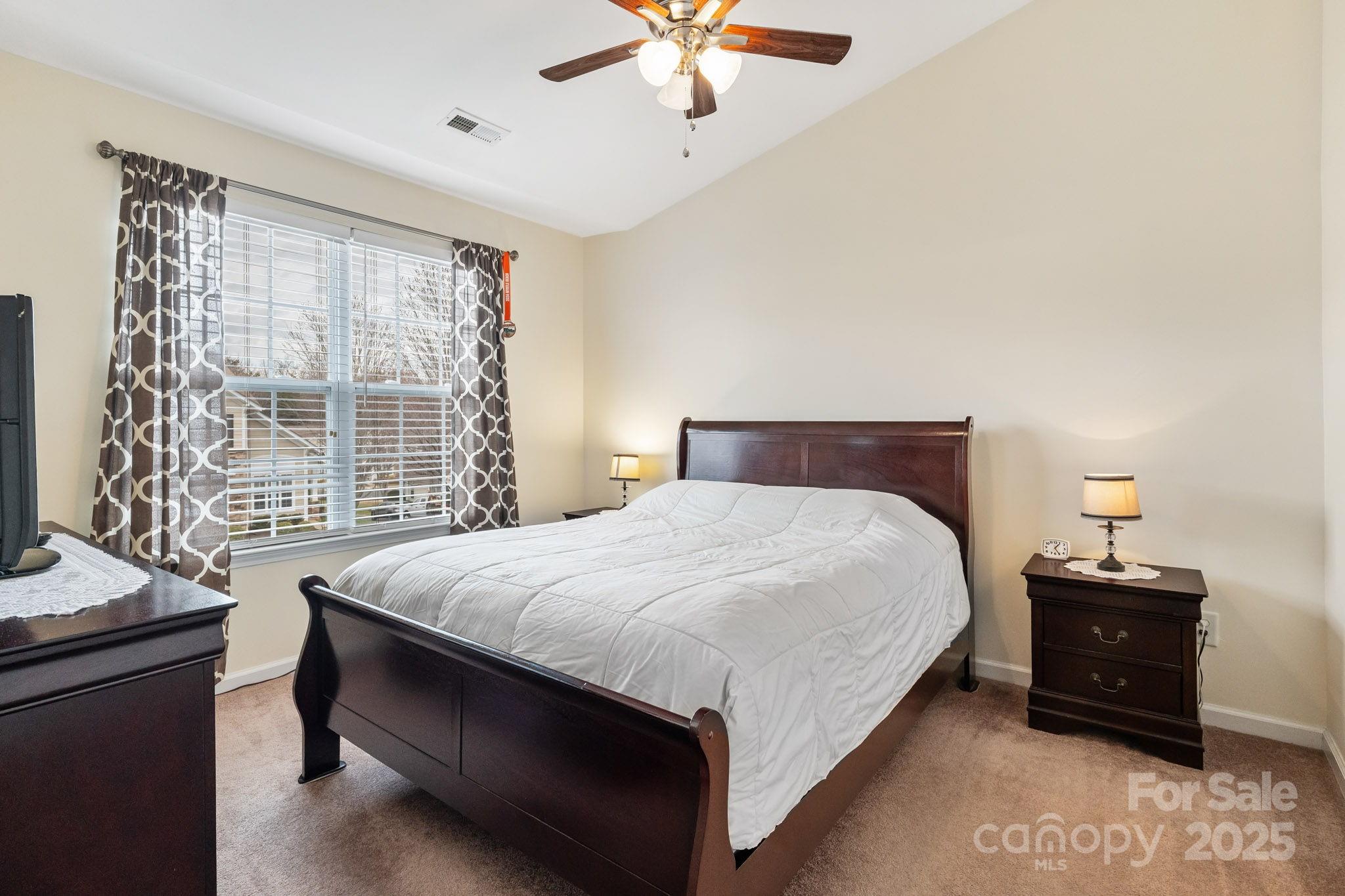 811 Gentlewinds Court Fort Mill, SC 29708 - Photo 13 of 25 a bedroom with a bed and window