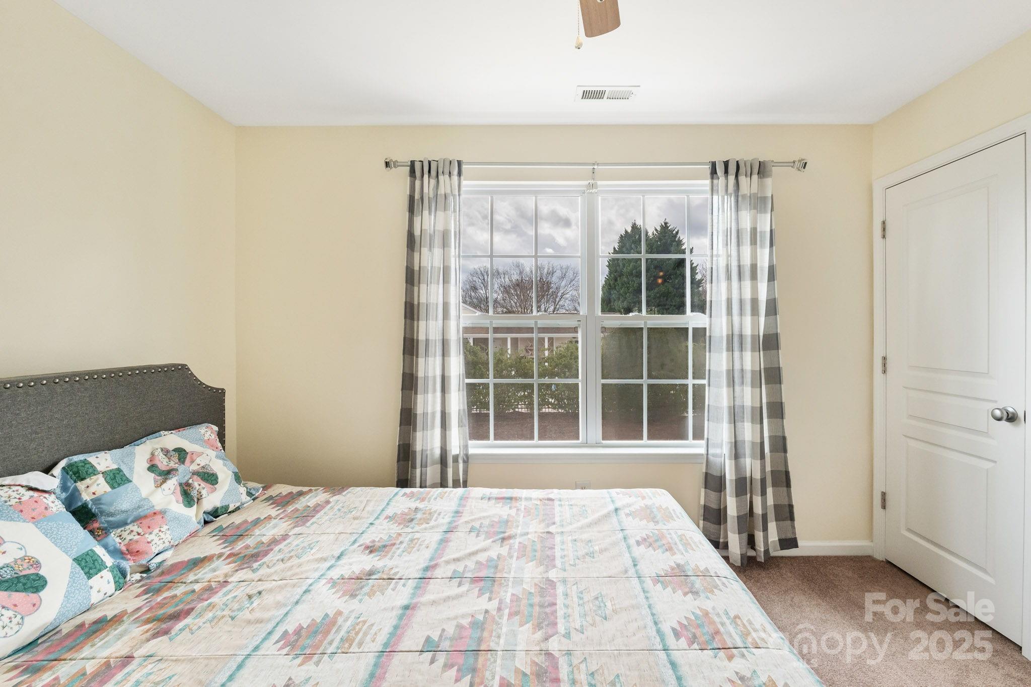 811 Gentlewinds Court Fort Mill, SC 29708 - Photo 17 of 25 a bedroom with a bed and a window