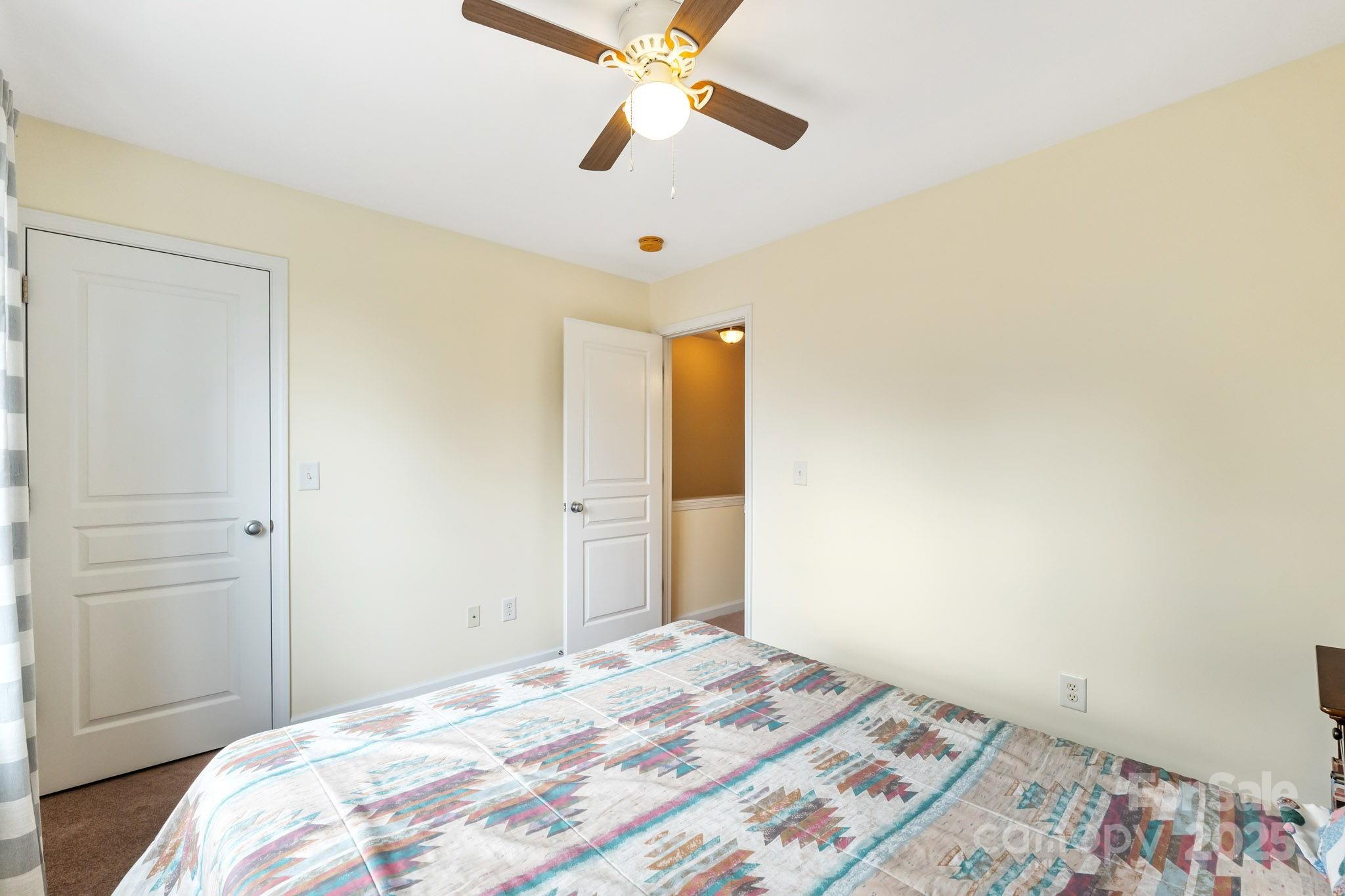 811 Gentlewinds Court Fort Mill, SC 29708 - Photo 19 of 25 a bedroom with a bed and a chandelier