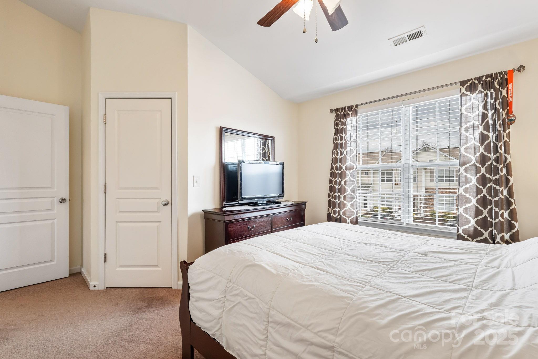 811 Gentlewinds Court Fort Mill, SC 29708 - Photo 22 of 25 a bedroom with a bed and a flat screen tv