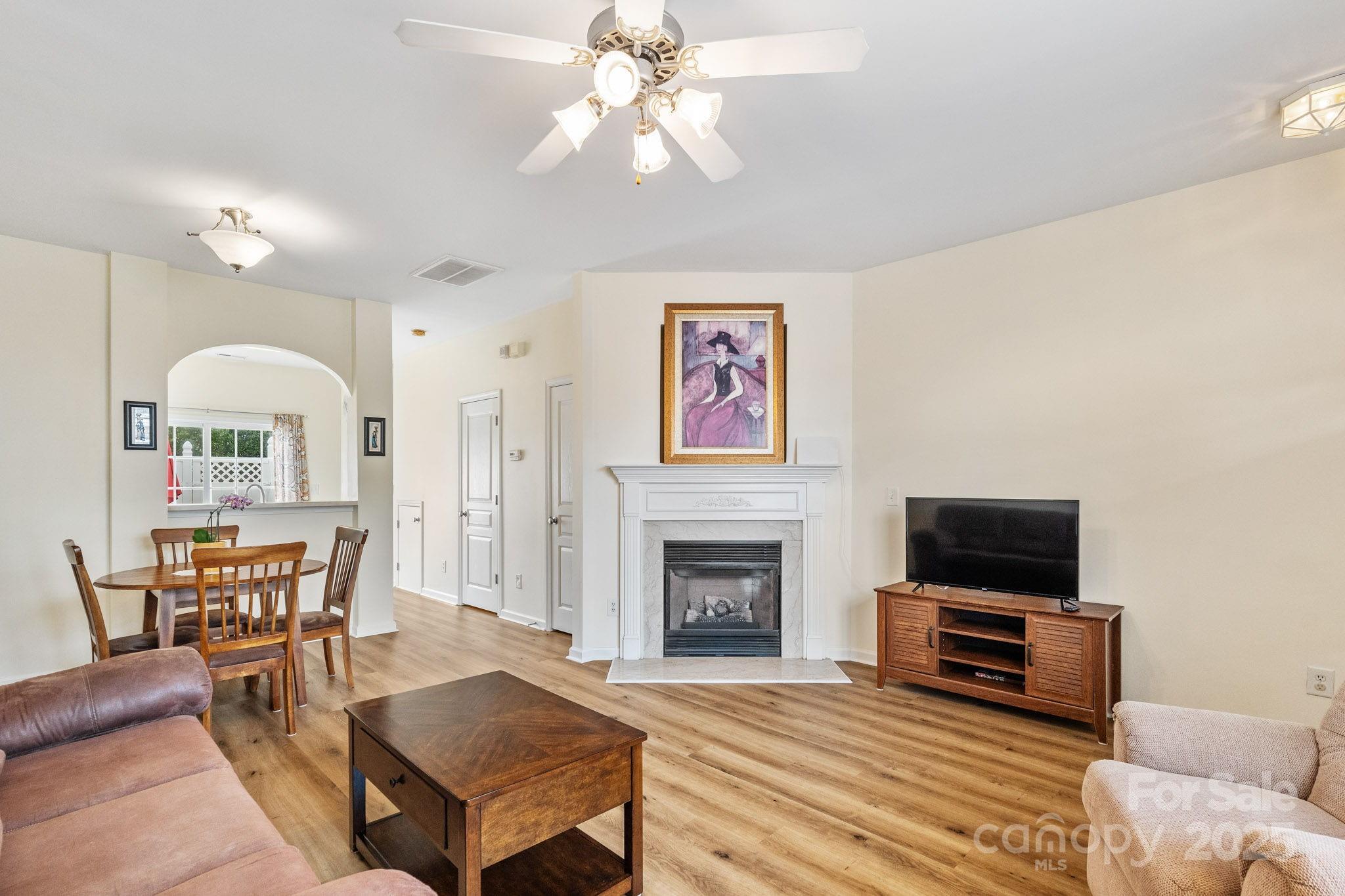 811 Gentlewinds Court Fort Mill, SC 29708 - Photo 5 of 25 a living room with furniture a flat screen tv and a fireplace