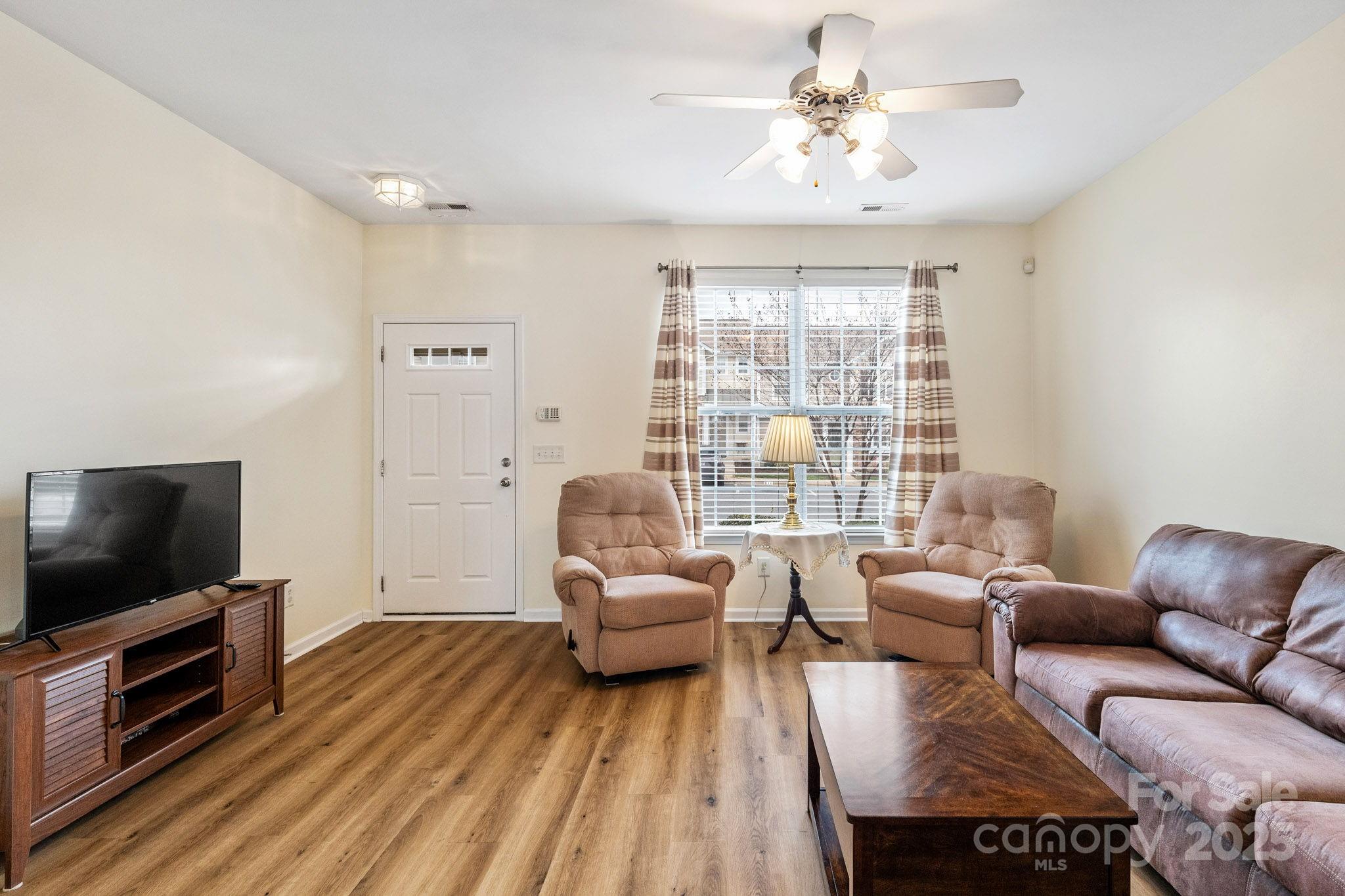 811 Gentlewinds Court Fort Mill, SC 29708 - Photo 6 of 25 a living room with furniture and a flat screen tv