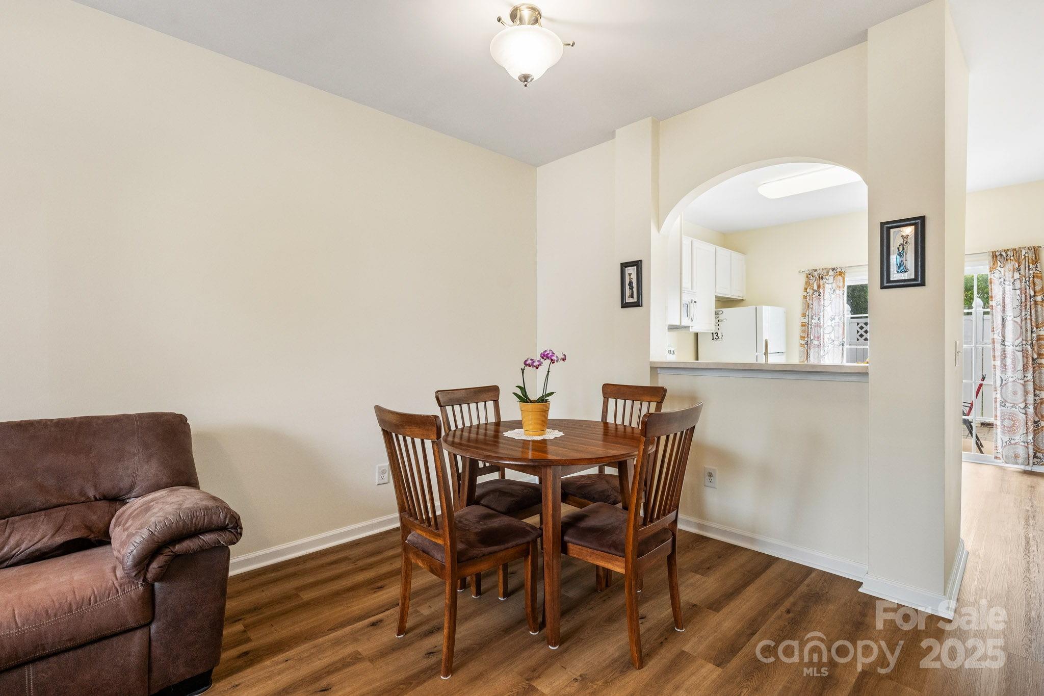 811 Gentlewinds Court Fort Mill, SC 29708 - Photo 8 of 25 a view of a dining room with furniture and wooden floor