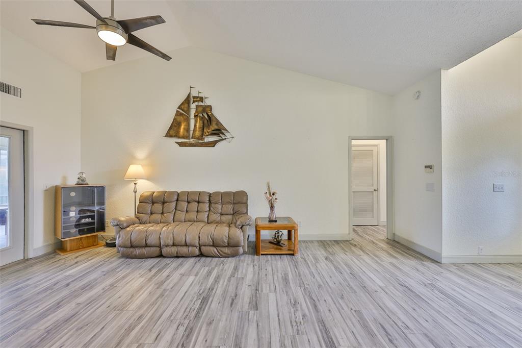 913 Allegro Lane Apollo Beach, FL 33572 - Photo 11 of 57 a living room with furniture and a wooden floor
