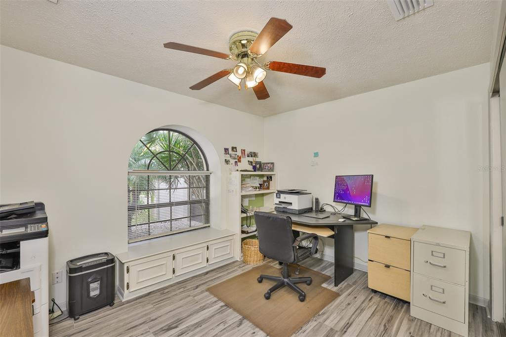 913 Allegro Lane Apollo Beach, FL 33572 - Photo 13 of 57 a workspace with furniture hardwood floor and a ceiling fan