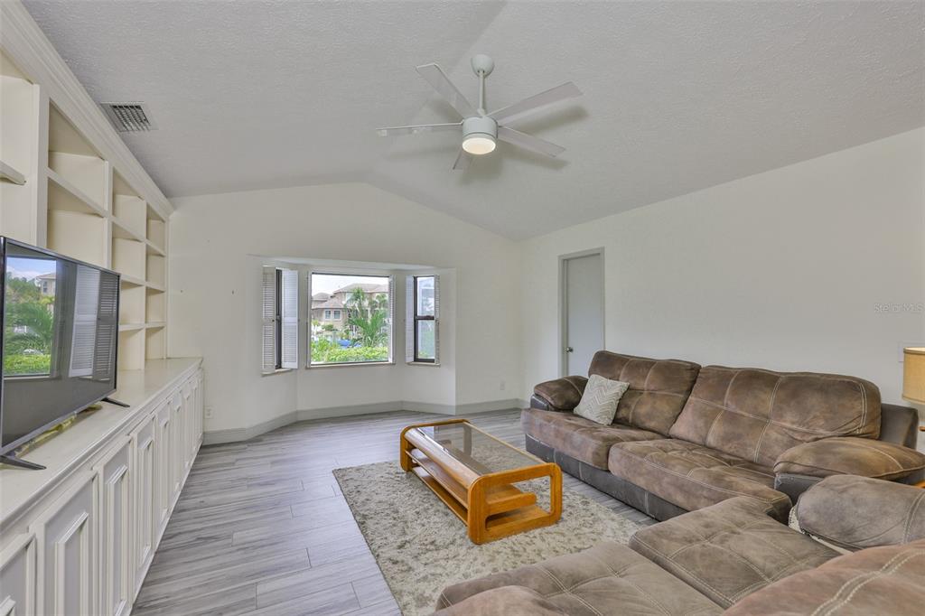913 Allegro Lane Apollo Beach, FL 33572 - Photo 16 of 57 a living room with furniture and a flat screen tv